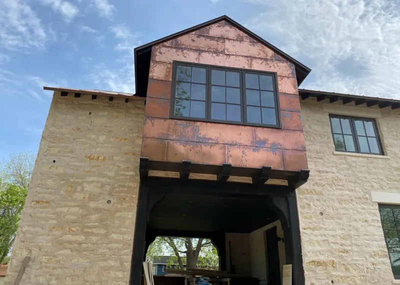 Copper metal panel facade on a stone building for Skylight Installation in North Salt Lake
